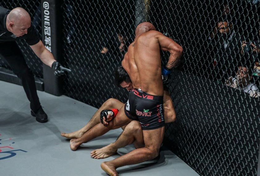 Demetrious Johnson applying a guillotine choke to Yuya Wakamatsu. - ONE photo