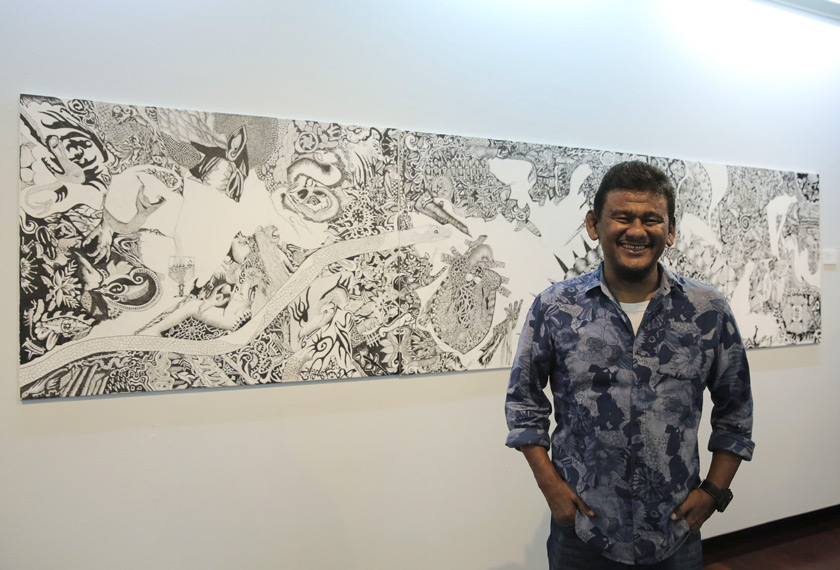 Ebby Yus disamping lukisannya yang dipamerkan di Galeri Shah Alam. - Foto: Astro AWANI/Shahir Omar