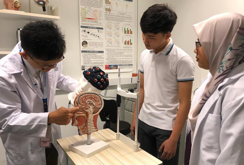 Feng sedang memberikan penjelasan tentang fungsi optikal topografi kepada dua rakannya.