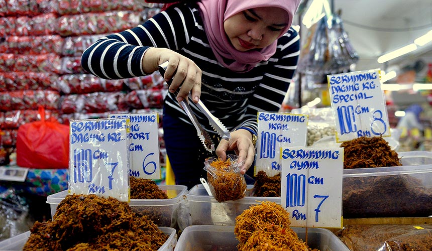 Peniaga membungkus serunding yang dijual dengan harga RM6 hingga RM10 setiap 100 gram di Pasar Besar Kedai Payang, Kuala Terengganu. --fotoBERNAMA