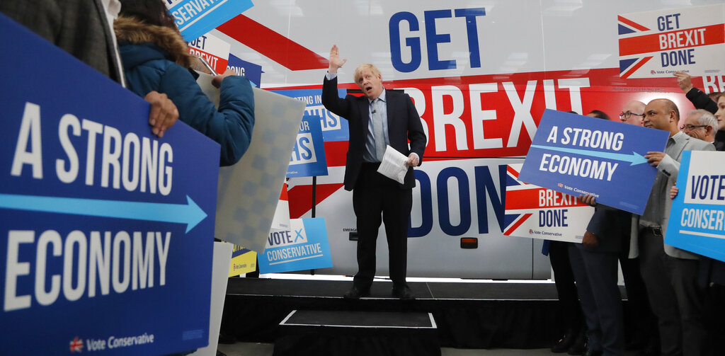 Britain's Prime Minister Boris Johnson addresses his supporters prior to boarding his General Election campaign trail bus in Manchester, England, Friday, Nov. 15, 2019. Britain goes to the polls on Dec. 12. (AP Photo/Frank Augstein, Pool)