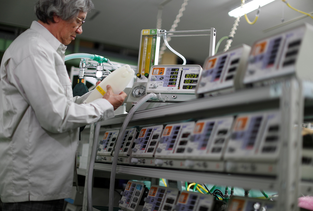 Metran Co. Chairman and CEO Kazufuku Nitta, who also uses the Vietnamese name Tran Ngoc Phuc, demonstrates the company's 'Compos X' ventilator, which was originally developed for animals but may be used for human coronavirus disease (COVID-19) patients, at its factory in Kawaguchi, north of Tokyo, Japan April 2, 2020. Picture taken April 2, 2020. REUTERS/Issei Kato