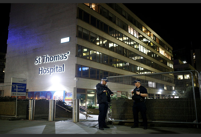 Police officers outside of the St Thomas' Hospital after British Prime Minister Boris Johnson was moved to intensive care after his coronavirus symptoms worsened, London, Britain, April 6, 2020. REUTERS