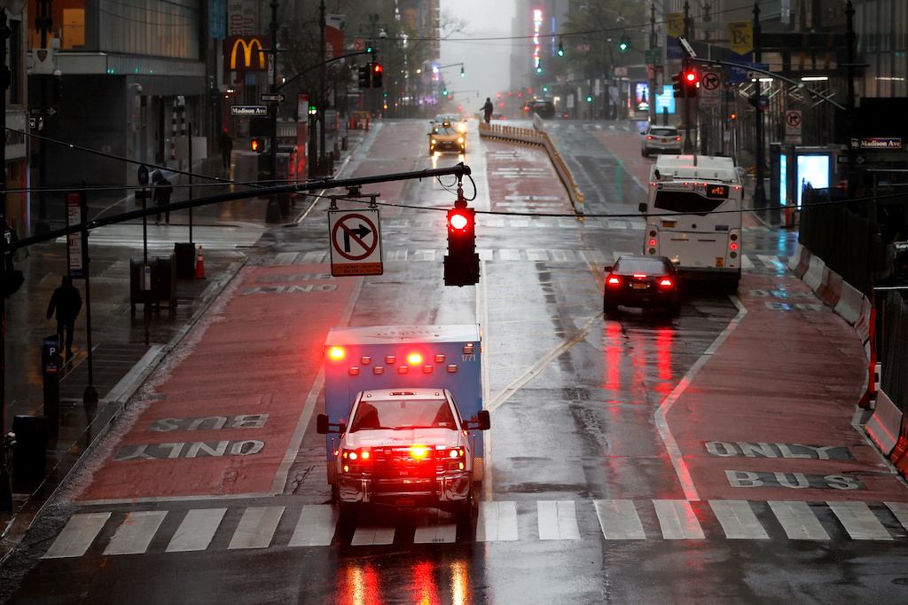 An ambulance drives across a nearly empty East 42nd Street in heavy rain and high winds in Manhattan during the outbreak of the coronavirus disease (COVID-19) in New York City, New York, U.S., April 13, 2020. REUTERS/Mike Segar