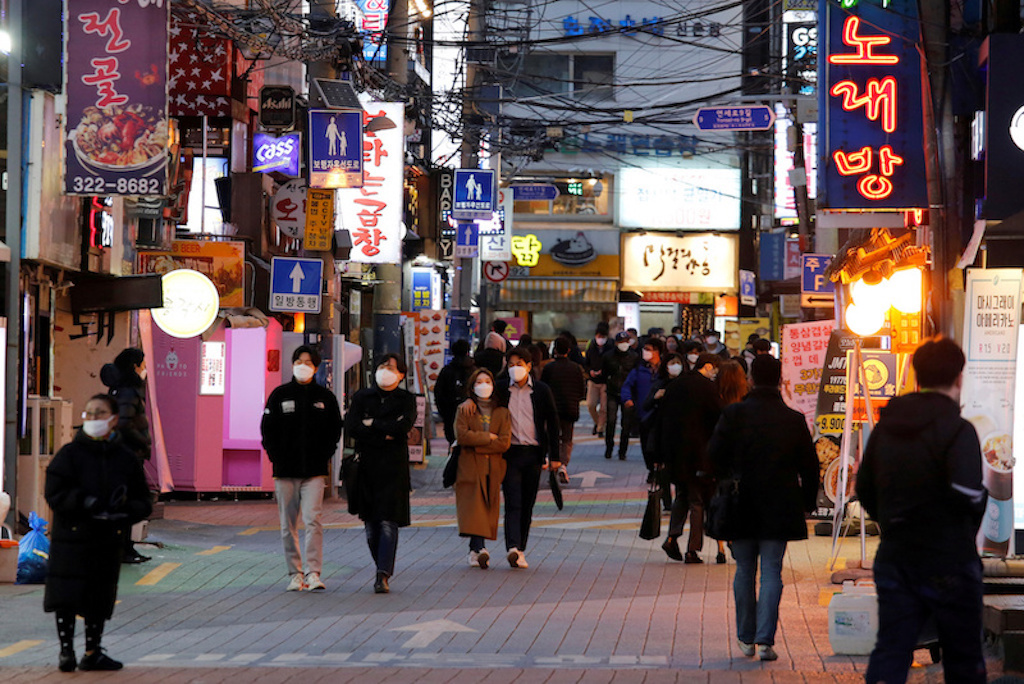 People wearing face masks to protect themselves against contracting the new coronavirus walk on a street in central Seoul, South Korea April 22, 2020 - REUTERS/Heo Ran/File Photo
