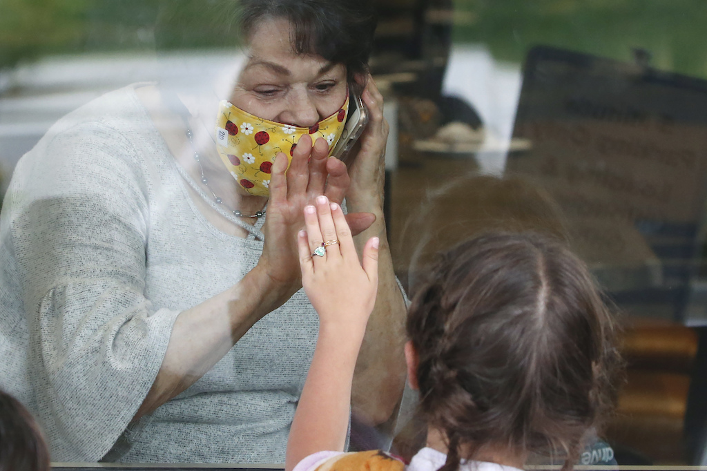 Raelene Critchlow, 86, receives a visit from her great-grandchild Camille Carter, 6, at Creekside Senior Living, Thursday, April 23, 2020, in Bountiful, Utah. Window visits help seniors connect to families despite coronavirus restrictions - AP Photo/Rick Bowmer