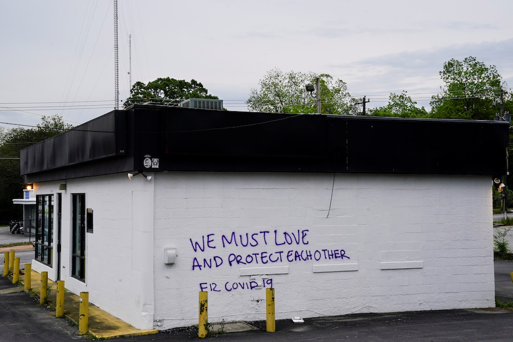 Graffiti with a positive message regarding coronavirus is seen on the side of a building days before the phased reopening of businesses and restaurants from coronavirus disease (COVID-19) restrictions in Atlanta, Georgia, U.S. April 22, 2020 - REUTERS/Elijah Nouvelage