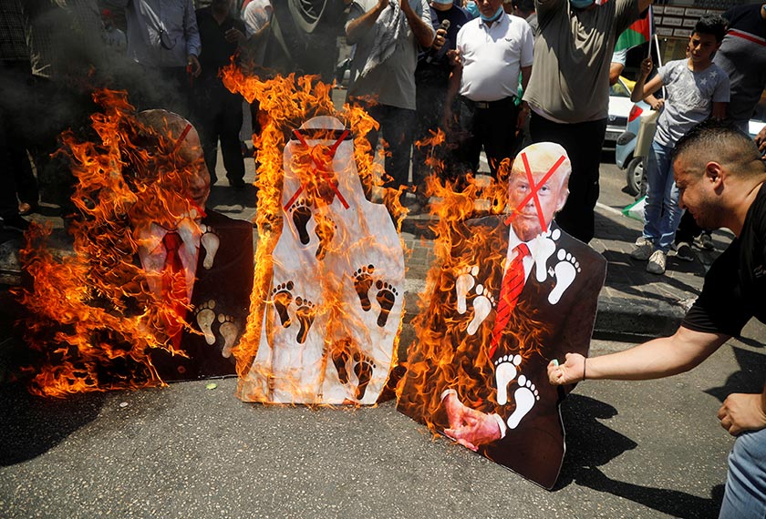 Palestinians burn cutouts depicting U.S. President Donald Trump and Abu Dhabi Crown Prince Mohammed bin Zayed al-Nahyan and Israeli Prime Minister Benjamin Netanyahu during a protest against the United Arab Emirates' deal with Israel to normalise relations, in Nablus in the Israeli-occupied West Bank August 14, 2020. REUTERS/Raneen Sawafta