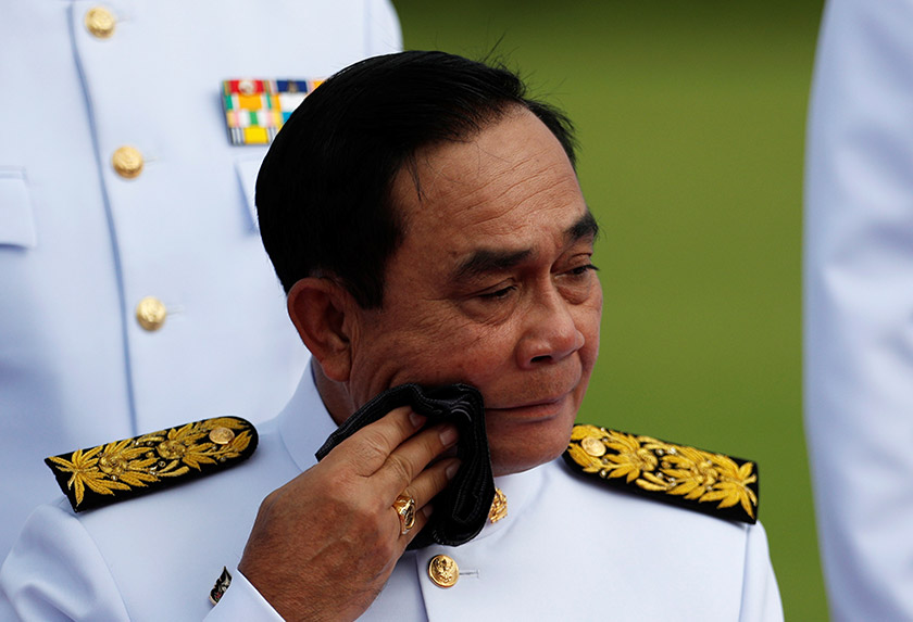 Thailand's Prime Minister Prayuth Chan-ocha wipes his face during a family photo session with new cabinet ministers at the Government House in Bangkok. REUTERSpic