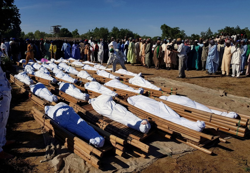 Men gather near dead bodies of people who were killed by militant attack, during a mass burial at Zabarmari, in the Jere local government area of Borno State, in northeast Nigeria, Nov 29, 2020. REUTERSpic