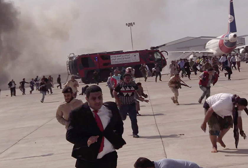 People run following an explosion at the airport in Aden, Yemen, shortly after a plane carrying the newly formed Cabinet landed on Wednesday, Dec. 30, 2020. No one on board the government plane was hurt but initial reports said several people at the airport were killed. (AP Photo)