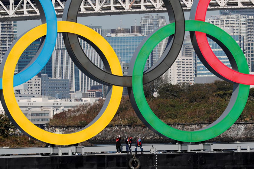 Workers reinstall giant Olympic rings at the waterfront area at Odaiba Marine Park, after they were temporarily taken down in August for maintenance amid the coronavirus disease (COVID-19) outbreak, in Tokyo, Japan December 1, 2020. REUTERS/Kim Kyung-Hoon
