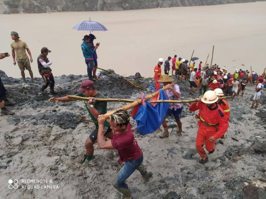 People carry a dead body following a landslide at a mining site in Phakant, Kachin State City, Myanmar July 2, 2020, in this picture obtained from social media. MYANMAR FIRE SERVICES DEPARTMENT/via REUTERS THIS IMAGE HAS BEEN SUPPLIED BY A THIRD PARTY.