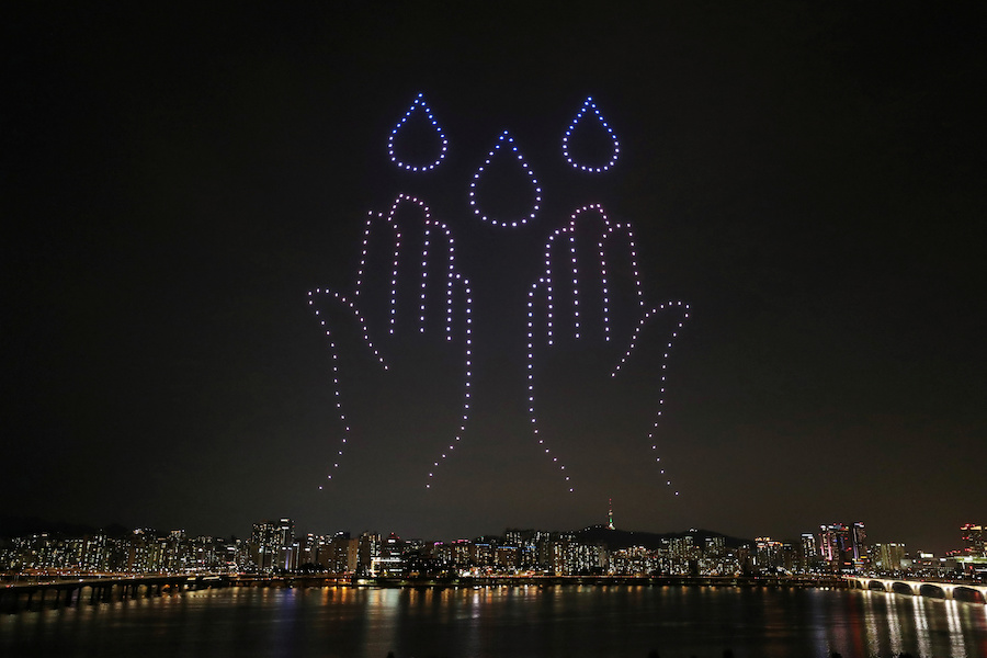 Drones fly over the Han river showing messages to support the country as measures to avoid the spread of the coronavirus disease (COVID-19) continue in Seoul, South Korea, July 4, 2020. Picture taken July 4, 2020. Yonhap via REUTERS