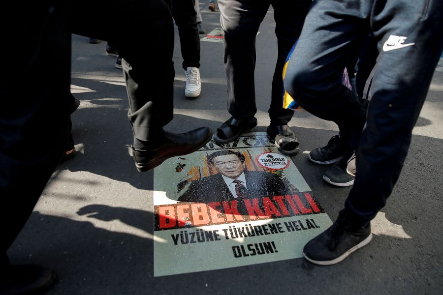 Ethnic Uighur demonstrators step on a poster with an image of Communist Party Secretary of Xinjiang Uighur Autonomous Region Chen Quanguo during a protest against China in front of the Chinese Consulate in Istanbul, Turkey, October 1, 2019. REUTERS/Huseyin Aldemir/File Photo