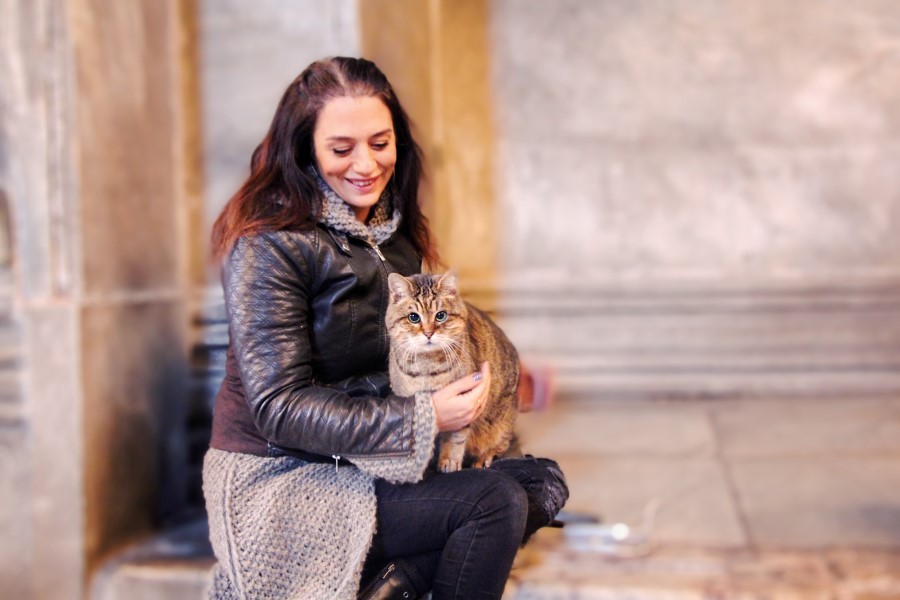 Umut Bahceci, a Turkish tour guide who runs an Instagram account for Gli, poses with Gli the cat of Hagia Sophia or Ayasofya in Istanbul, Turkey, December 23, 2017 - Courtesy of Umut Bahceci/HagiaSophiaCat/Handout via REUTERS