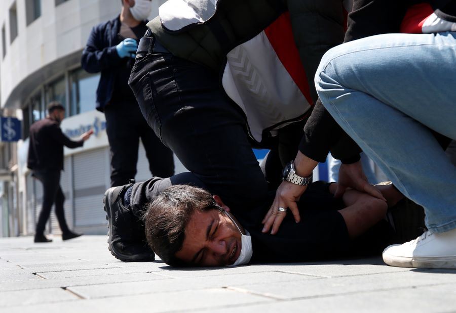 In this May 1, 2020, file photo, Turkish police officers arrest a demonstrator wearing a face mask for protection against the coronavirus, during May Day protests near Taksim Square, in Istanbul. The death of George Floyd has renewed scrutiny of immobilization techniques long used in policing around the world. (AP Photo/Emrah Gurel, File)