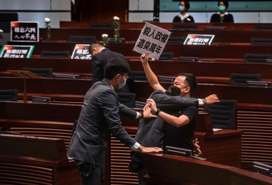 Pan-democratic legislator Chan Chi-chuen holding a placard reading 