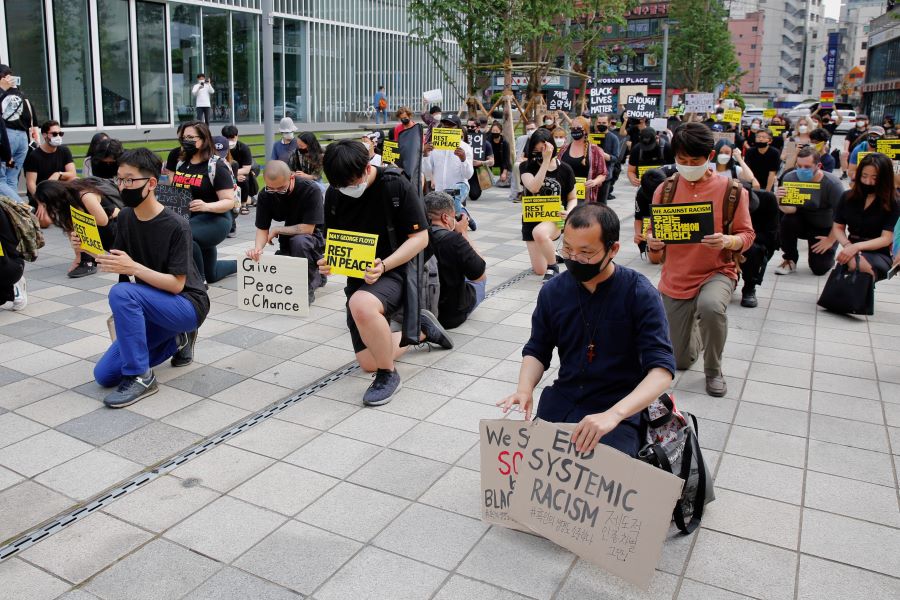 People kneel down as they march on the street in solidarity with protests against the death in Minneapolis police custody of George Floyd in Seoul, South Korea June 6, 2020 - REUTERS/Heo Ran