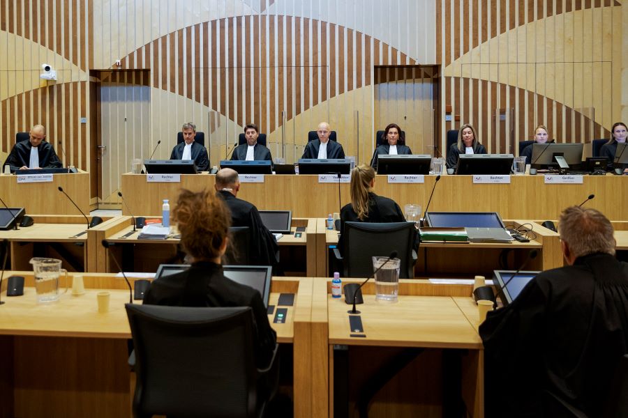 Presiding judge Hendrik Steenhuis, rear, fourth from left, opens the court session as the trial resumed at the high security court building at Schiphol Airport, near Amsterdam, Monday, June 8, 2020, for three Russians and a Ukrainian charged with crimes including murder for their alleged roles in the shooting down of Malaysia Airlines Flight MH17 over eastern Ukraine nearly six years ago. (AP Photo/Robin van Lonkhuijsen, POOL)