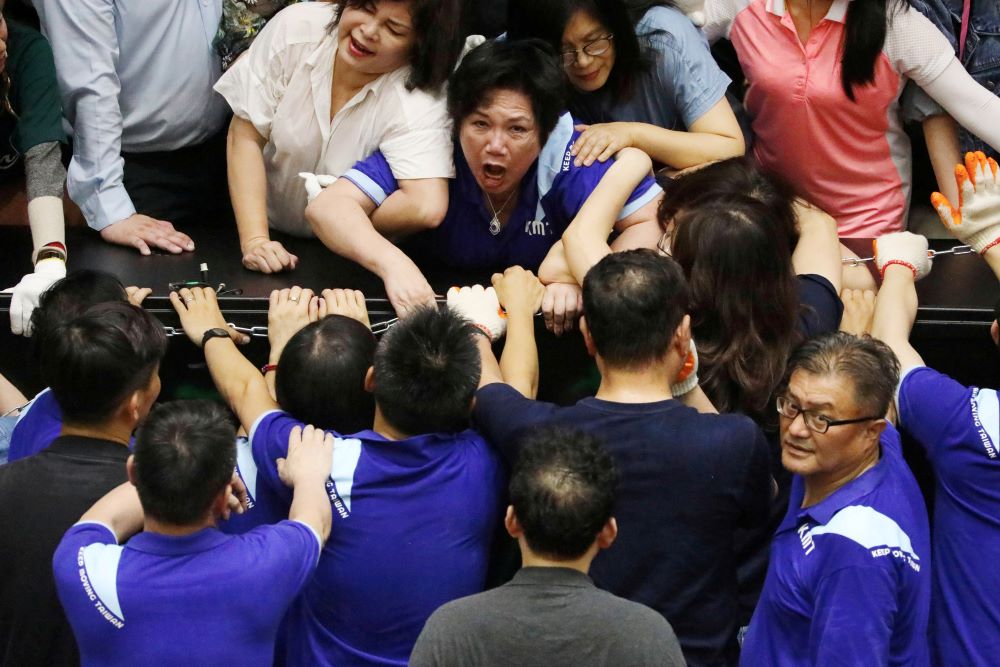 Lawmakers from Taiwan's ruling Democratic Progressive Party (DPP) scuffle with lawmakers from the main opposition Kuomintang (KMT) party, who have been occupying the Legislature Yuan, in Taipei, Taiwan, June 29, 2020. REUTERS/Ann Wang