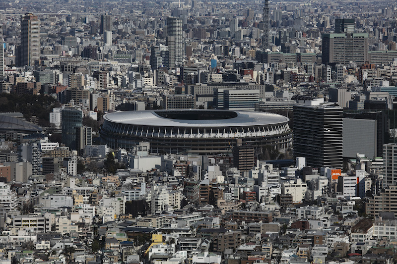 In this March 3, 2020, file photo, the New National Stadium, a venue for the opening and closing ceremonies at the Tokyo 2020 Olympics, is seen from Shibuya Sky observation deck in Tokyo. The tentacles of cancelling the Tokyo Olympics — or postponing or staging it in empty venues — would reach into every corner of the globe, much like the spreading virus that now imperils the opening ceremony on July 24. (AP Photo/Jae C. Hong, File)