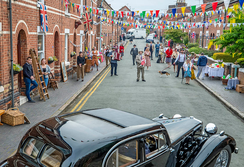 The residents of Cambrian Road in Chester dress up in 1945 clothing and have a social distancing tea party to mark the 75th anniversary of VE Day, May 8, 2020. (AP Photo)