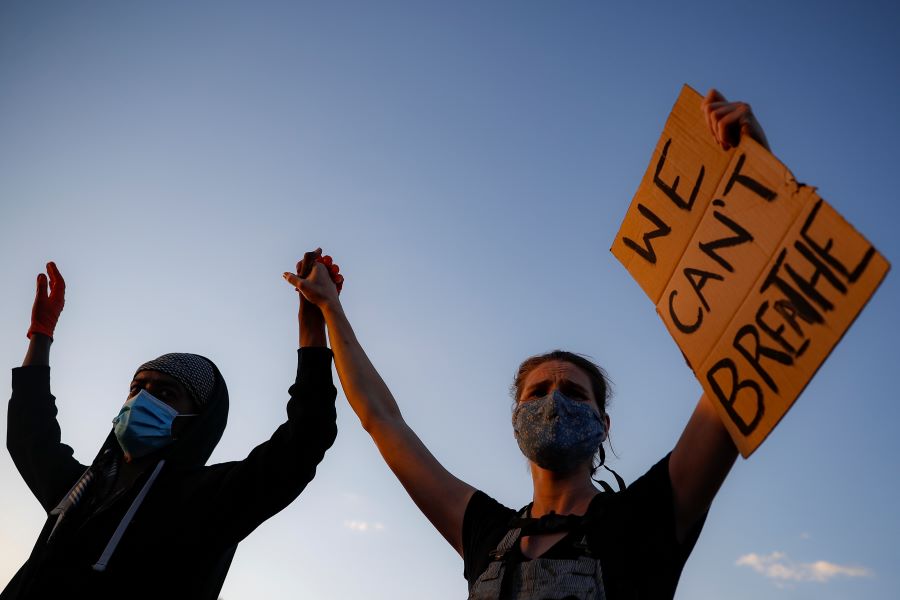 Protestors demonstrate on University Avenue while holding a 