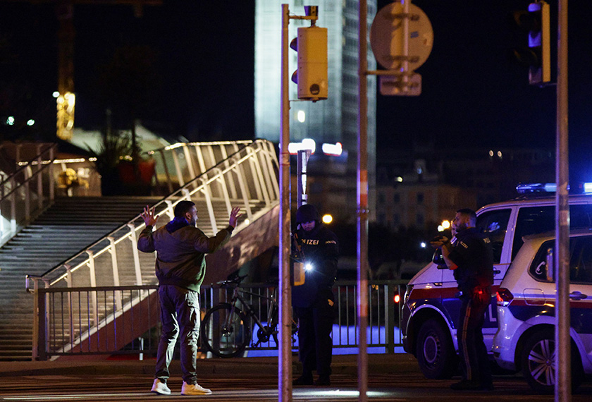 Police officers check a person on a street after exchanges of gunfire in Vienna, Austria November 2, 2020. REUTERS/Lisi Niesner