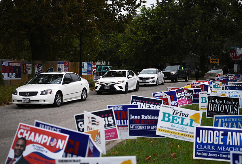 A line of cars drive in for an event encouraging community members to vote in the upcoming presidential election at an early voting site in Houston, Texas, U.S., October 25, 2020. REUTERS/Callaghan O'Hare