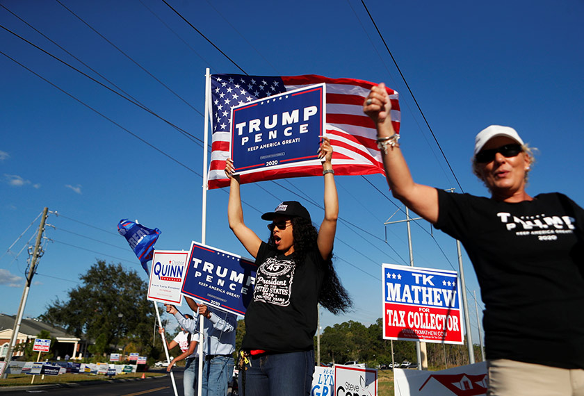 U.S. President Donald Trump supporters campaign near the Maureen B. Gauzza Public Library polling station where voters cast their ballots in the 2020 U.S. presidential election on election day, in Tampa, Florida, U.S. November 3, 2020. REUTERS/Octavio Jones