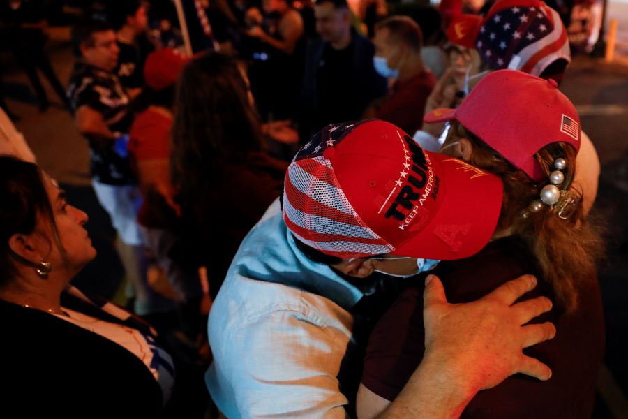 Supporters of U.S. President Donald Trump hugs during the 2020 U.S. presidential election, in Miami, Florida, U.S., November 4, 2020. REUTERS/Marco Bello