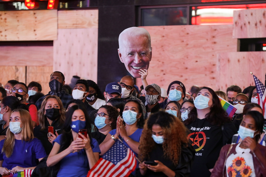 People celebrate media announcing that Democratic U.S. presidential nominee Joe Biden has won the 2020 U.S. presidential election, at Times Square in New York City, U.S. November 7, 2020. REUTERS/Jeenah Moon
