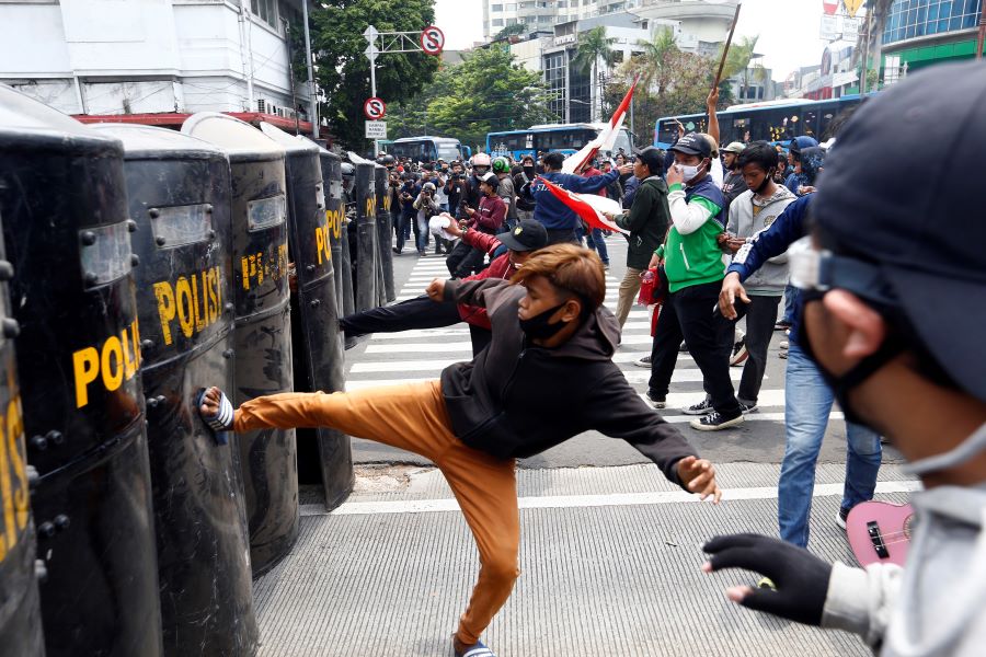 Demonstrators clash with police officers following a protest against the government's labor reforms in a 