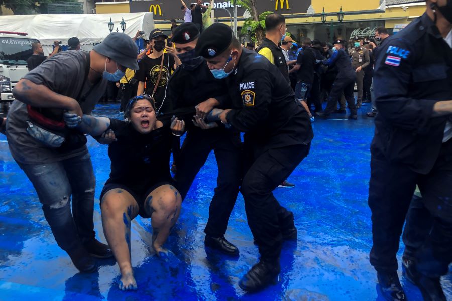 Police officers detain a pro-democracy activist during a protest against government and monarchy near the Democracy Monument in Bangkok, October 13, 2020. REUTERS
