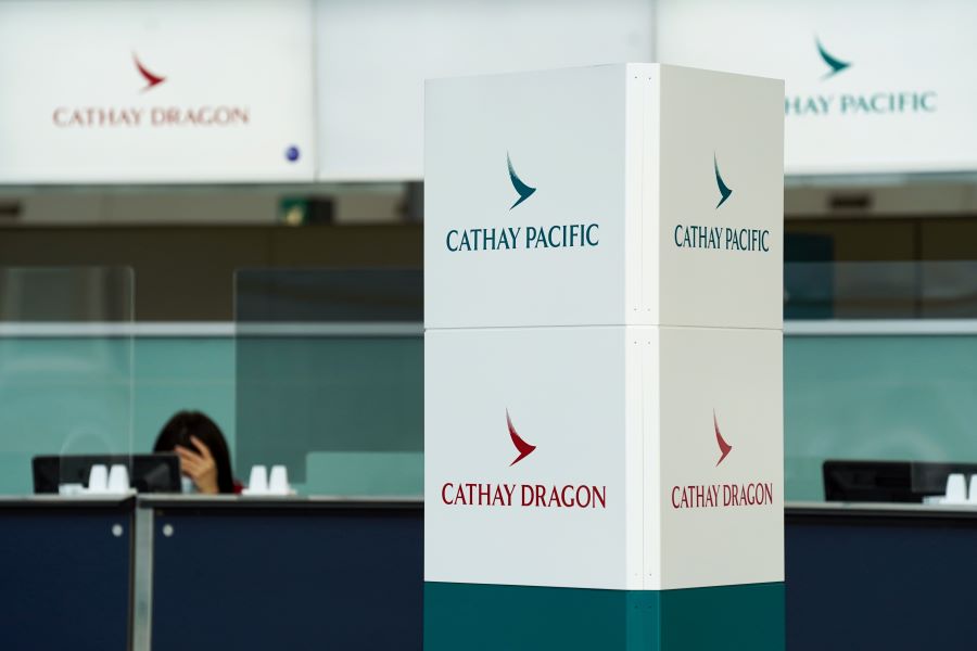 Cathay Pacific and Cathay Dragon logos are seen near a counter at Hong Kong International Airport, China October 20, 2020. REUTERS
