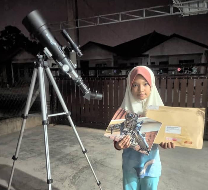 Aisyah Musryidah Binti Mohammad Ariff, year 5 student from SK Kuala Berang Terengganu participated in the citizen science Galaxy Cruise project, and received souvenirs from Apadilangit and NAOJ. Photo: Wan Nur Amira Binti Wan Jantan/ Apadilangit clan FB G