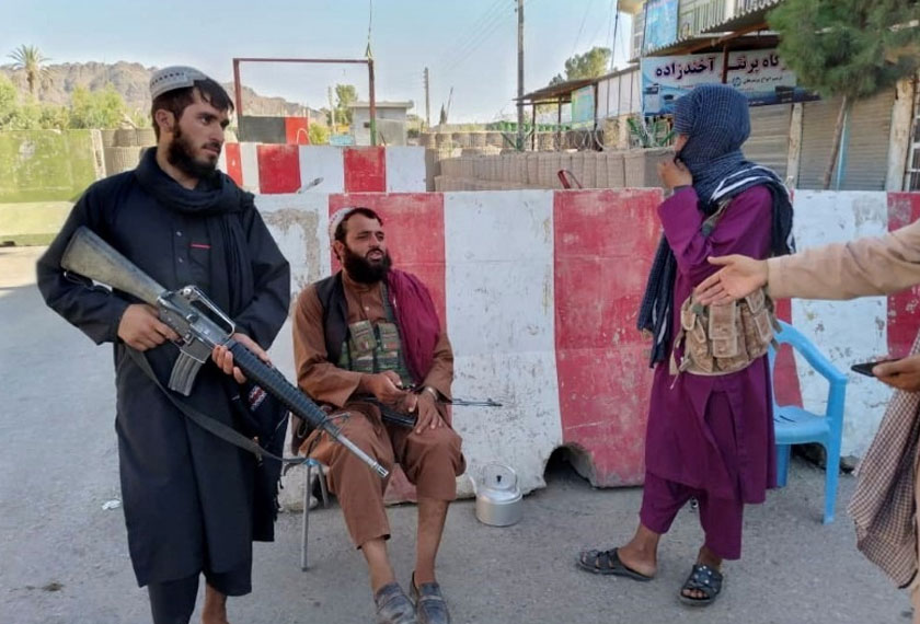 Taliban fighters stand guard at a check point in Farah, Afghanistan August 11, 2021. -REUTERS
