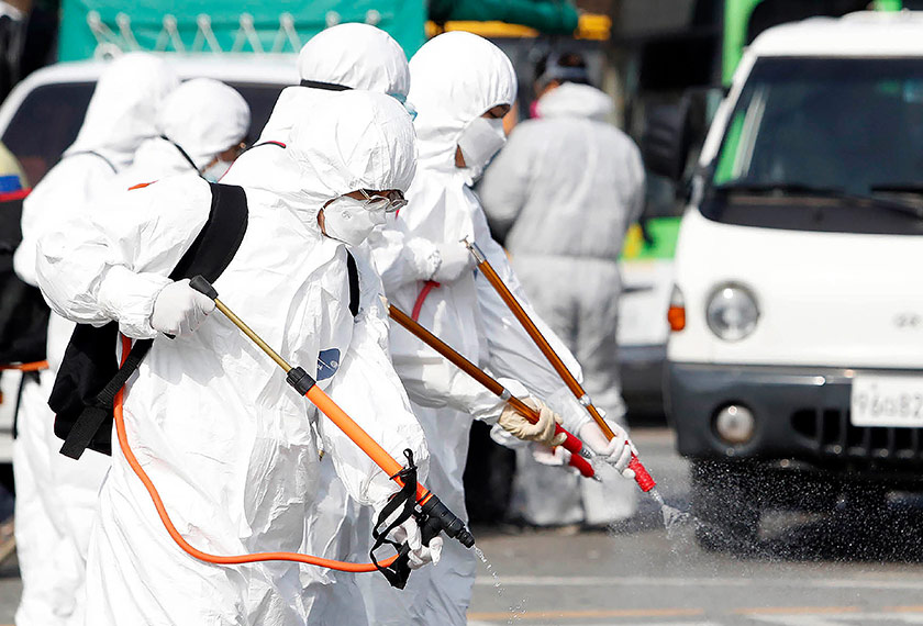 Health workers wearing Personal Protective Equipment (PPE) seen disinfecting an area. - AWANI/Filepic