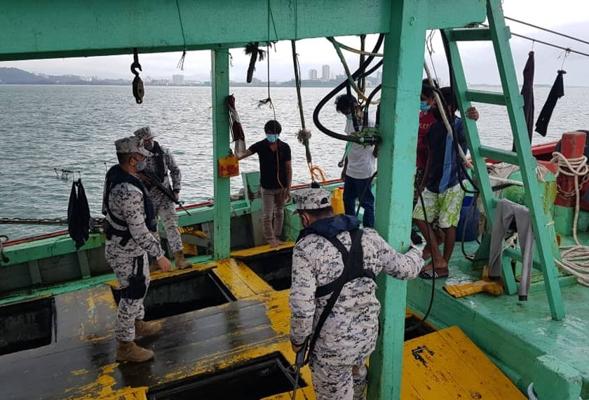   Pasukan APMM membuat pemeriksaan di atas sebuah bot nelayan untuk memastikan tiada unsur pencerobohan haram atau pelanggaran undang-undang lain. - Astro AWANI