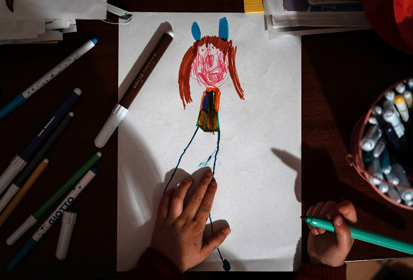 Bianca Toniolo, 3, draws a picture at home as she quarantines with her family after they had contact with someone with coronavirus disease (COVID-19), in this picture taken by her father, via REUTERS