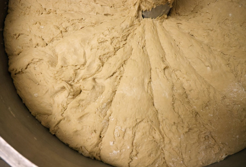 French baguettes dough is kneaded in a machine at 