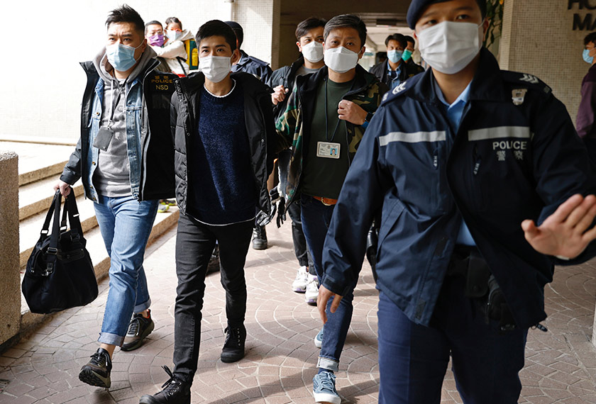 Pro-democracy activist Lester Shum is taken away by police officers after over 50 Hong Kong activists arrested under security law as crackdown intensifies, in Hong Kong, China January 6, 2021. REUTERS/Tyrone Siu