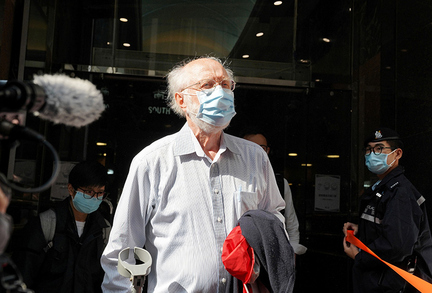 American lawyer John Clancey walks out of a building as he is taken away by police officers in Hong Kong, China January 6, 2021. REUTERS/Lam Yik