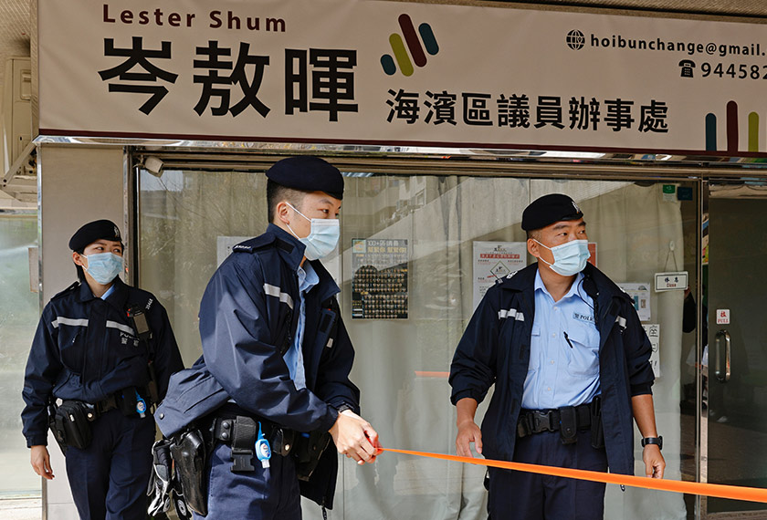 Police stand guard outside pro-democracy activist Lester Shum’s office after over 50 Hong Kong activists arrested under security law as crackdown intensifies, in Hong Kong, China January 6, 2021. REUTERS/Tyrone Siu