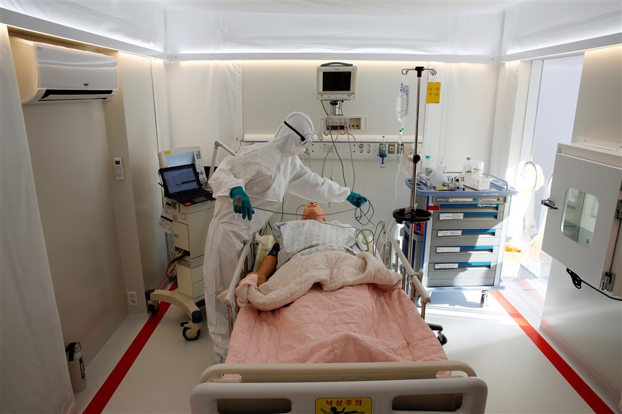 A medical worker uses a simulation mannequin inside the Mobile Clinic Module outside Korea Cancer Center Hospital in Seoul, South Korea, January 8, 2021. REUTERS/Heo Ran