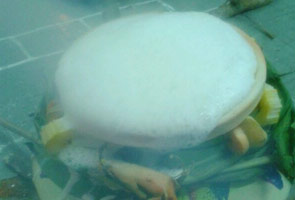 The sweet rice dish is cooked in a painted claypot with turmeric plant tied around the claypot. REUTERS file pic