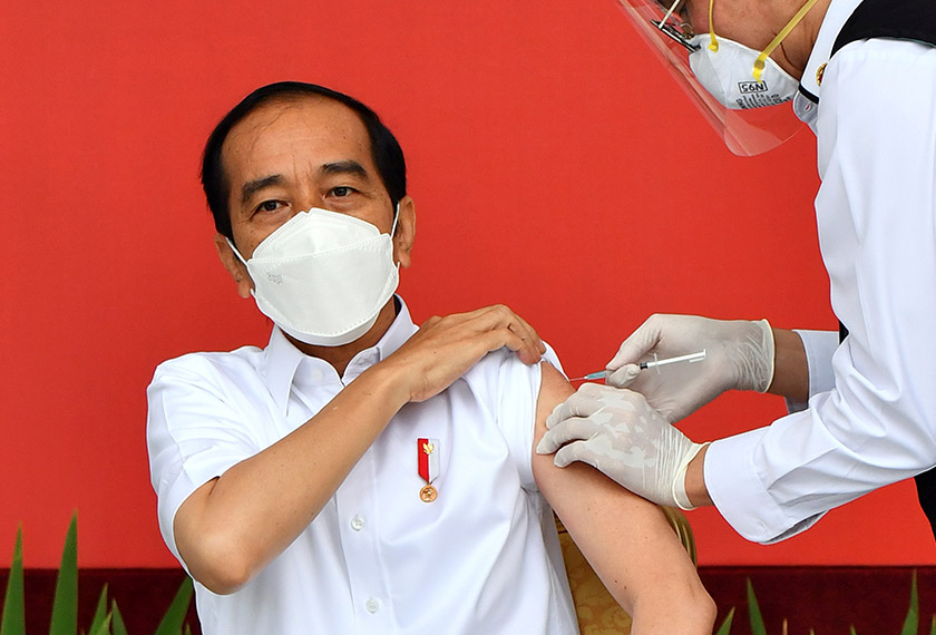Indonesian President Joko Widodo receives a shot of the coronavirus disease (COVID-19) vaccine at the Merdeka Palace in Jakarta, Indonesia, January 13, 2021. Courtesy of Agus Suparto/Indonesian Presidential Palace/Handout via REUTERS