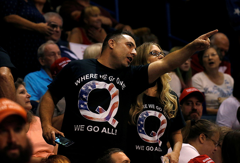 Supporters wearing shirts with the QAnon logo, chat before U.S. President Donald Trump takes the stage during his Make America Great Again rally in Wilkes-Barre, PA, U.S., August 2, 2018. REUTERS/Leah Millis