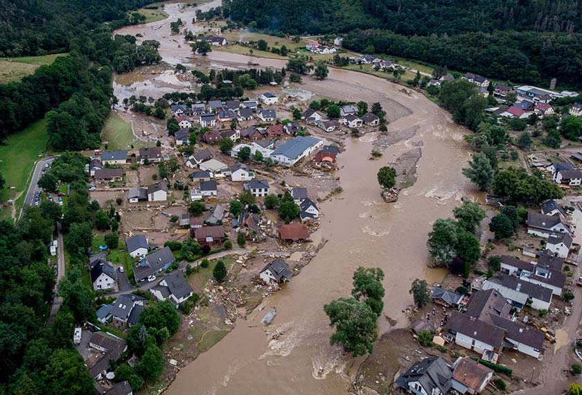 The Ahr river floats past destroyed houses in Insul, Germany, Thursday, July 15, 2021. Due to heavy rain falls the Ahr river dramatically went over the banks the evening before. (AP Photo/Michael Probst)
